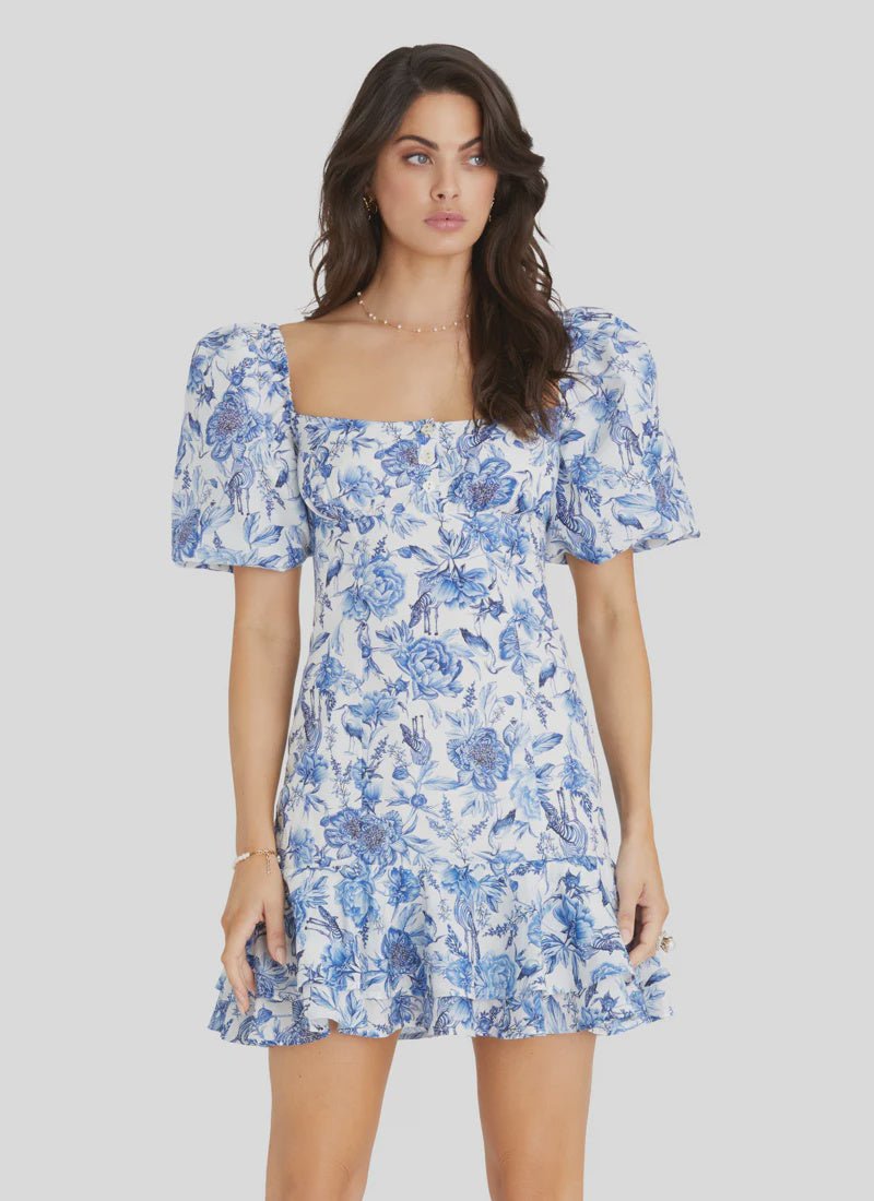 Model wearing Aqua Blu Australia Azalea Scarlet Mini Dress in blue floral print with puff sleeves and square neckline.