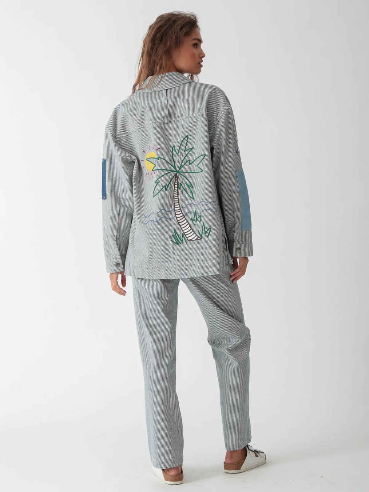 Back view of the Electric & Rose Embroidered Chore Jacket showing the vertical indigo pinstripes and relaxed silhouette.