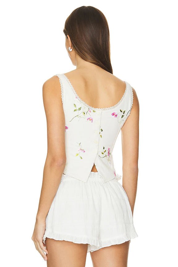 Rear view of the LoveShackFancy Rhapsody Bustier highlighting the back button closure and delicate lace detailing.