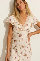 Close-up of the Auguste The Label Rianne Midi Dress in Ivory, showing the lace-trimmed V-neckline and floral satin jacquard texture.