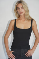 Woman wearing the LNA Scoop Rib Tank in Black available at Endless Waves Boutique