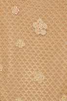 Close-up detail of LoveShackFancy Vreya dress showing hand-crocheted flowers, metallic gold yarn, and delicate sequin embroidery.