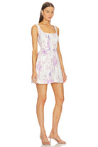 Side view of LoveShackFancy Lowery Mini Dress in Spanish Lilac showing the corset bodice and ruffled waistline.