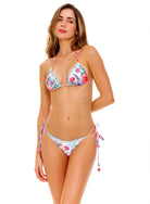 Front view of the Agua Bendita Chroma Lolita Bikini Top featuring a vibrant floral print with intricate hand-beaded embroidery on a white background, styled with matching side-tie bottoms
