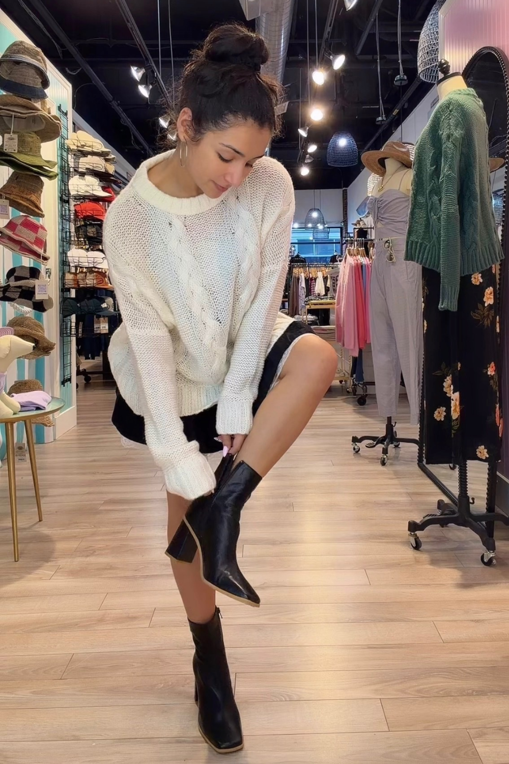 Alexa zipping up a boot wearing a cute fall inspired outfit 