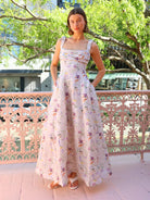 Model wearing the Aqua Blu Adele Maxi Dress in Moonflower print, a floral linen and silk blend dress with a pleated bodice and square neckline, perfect for garden parties or wedding guests.