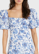 Model wearing Aqua Blu Australia Azalea Scarlet Mini Dress in blue floral print with puff sleeves and square neckline.