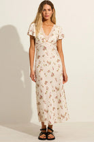 Full-length view of the Auguste The Label Rianne Midi Dress in Ivory floral, featuring a flattering bias-cut silhouette.