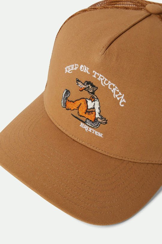 Close-up of the Brixton Stride 'Keep on Truckin' embroidery, featuring a detailed wolf graphic in orange and cream on a Washed Copper crown.