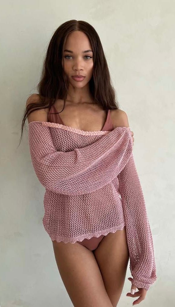 Woman wearing the Rose Tenia knitted sweater by BTB Los Angeles over her shoulders 