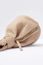 Detail view of the Bone Cleobella Celine Woven Handbag showing the hand-braided leather and side zip closure.