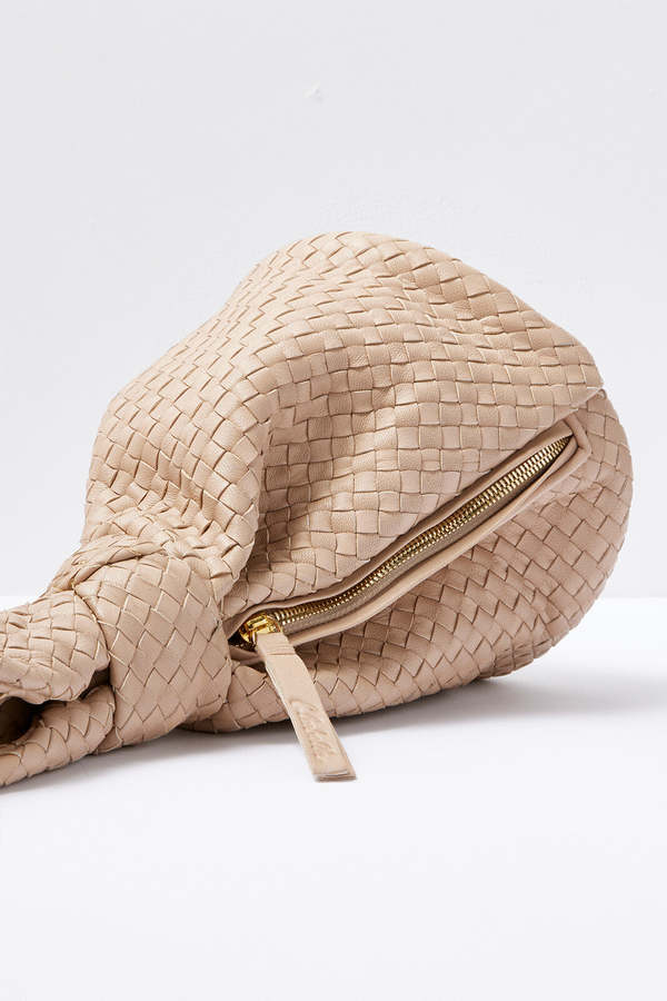 Detail view of the Bone Cleobella Celine Woven Handbag showing the hand-braided leather and side zip closure.