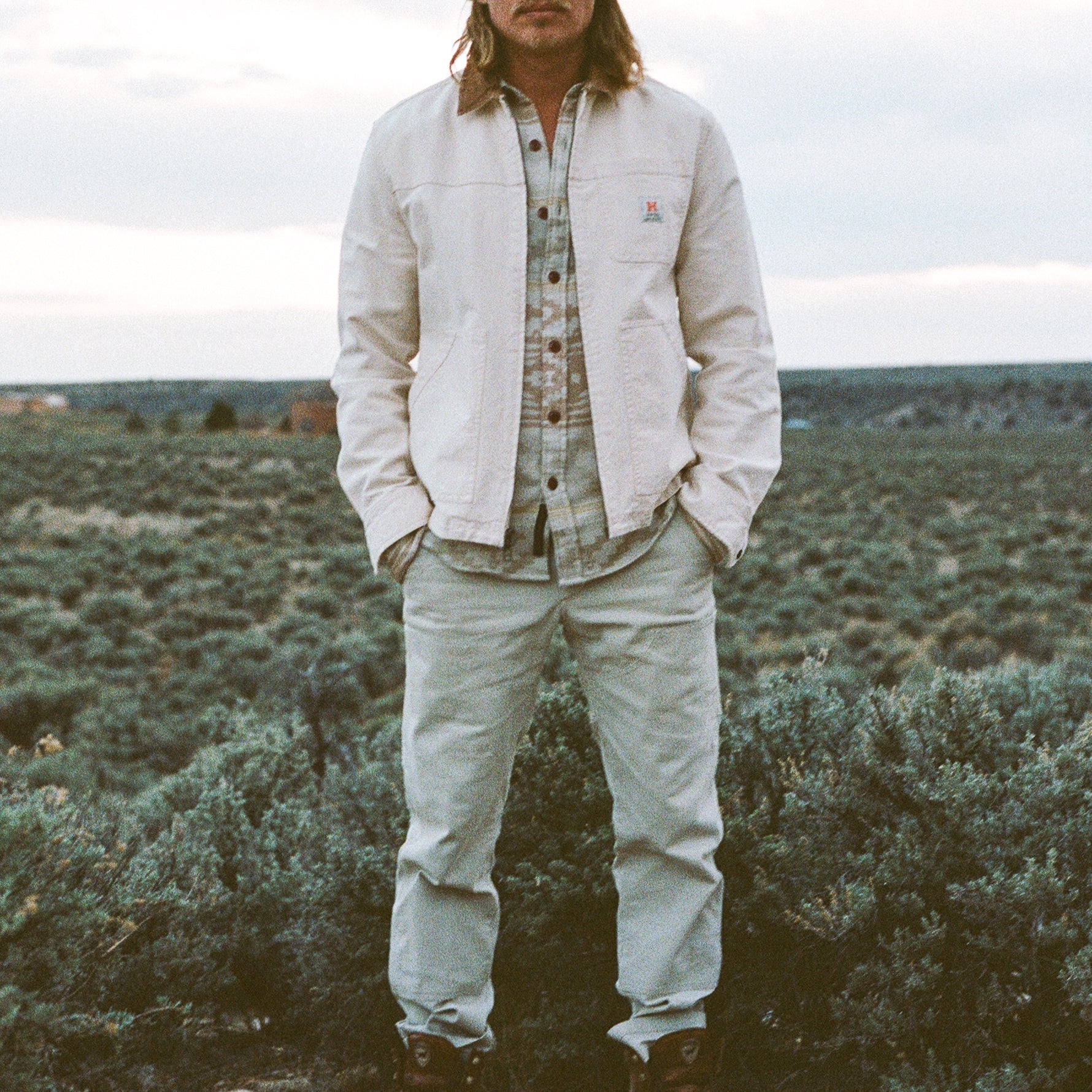 Lifestyle photo showing the Howler Bros Conveyer Coat in Au Naturel -  Endless Waves
