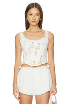 LoveShackFancy Rhapsody Bustier in Antique White featuring a pink floral print, lace trim neckline, and structured corset boning.