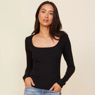 Woman wearing the Monrow square neck 90s rib long sleeve in black with denim.