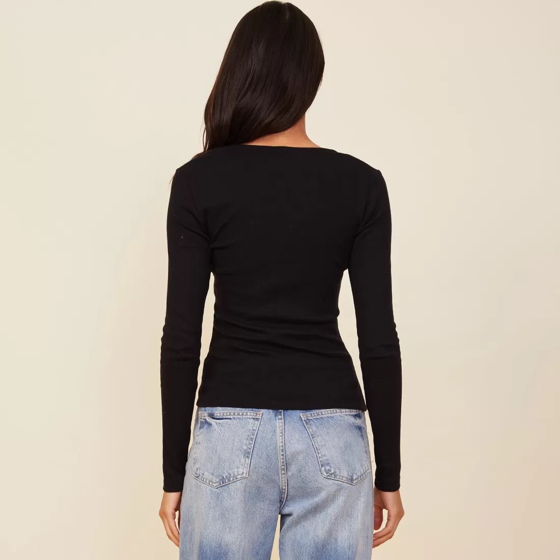 Woman wearing the Monrow square neck 90s rib long sleeve in black with denim.