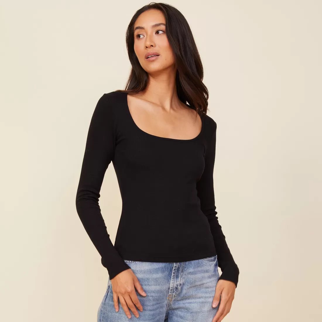 Woman wearing the Monrow square neck 90s rib long sleeve in black with denim.