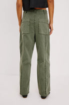 Rear view of a woman modeling the Rails Lunar pants in Military Olive showing off the oversized cargo pockets and seam-work.